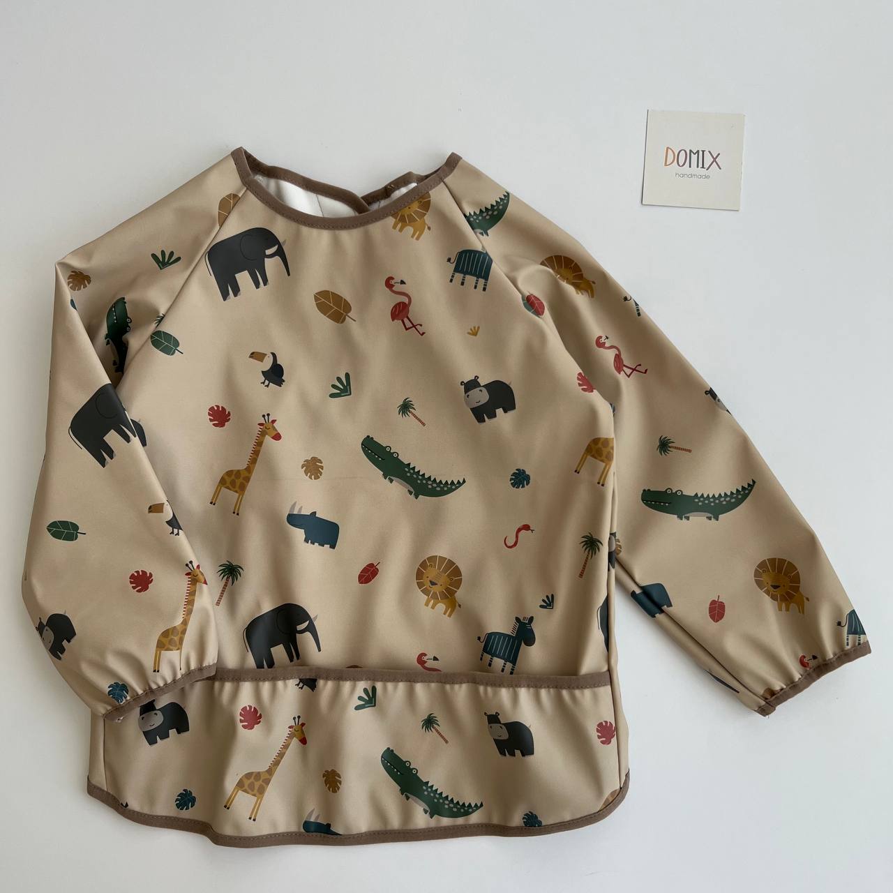Beige long-sleeve shirt with animal pattern on a white background