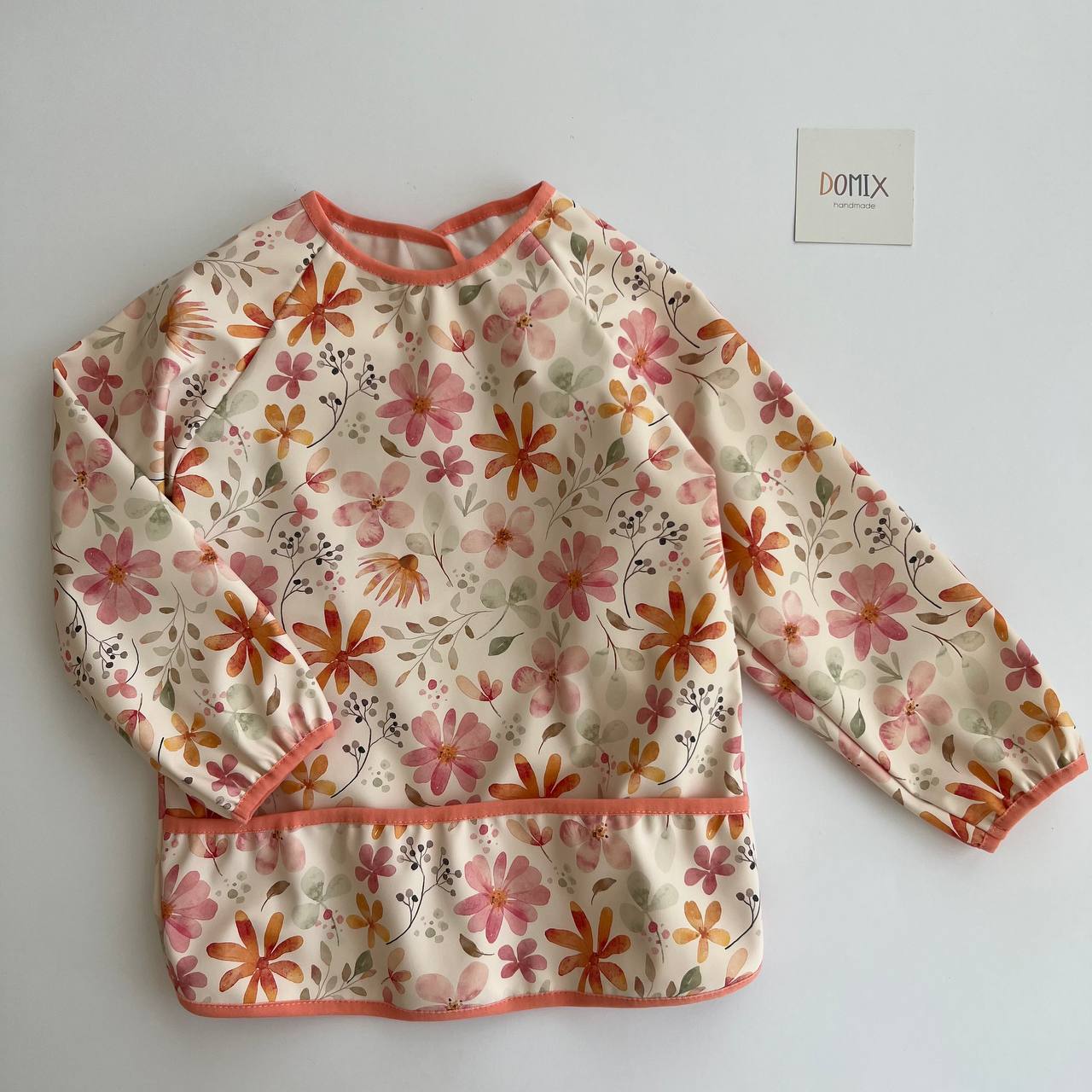 Floral-patterned long-sleeve shirt on a plain background with a brand label.