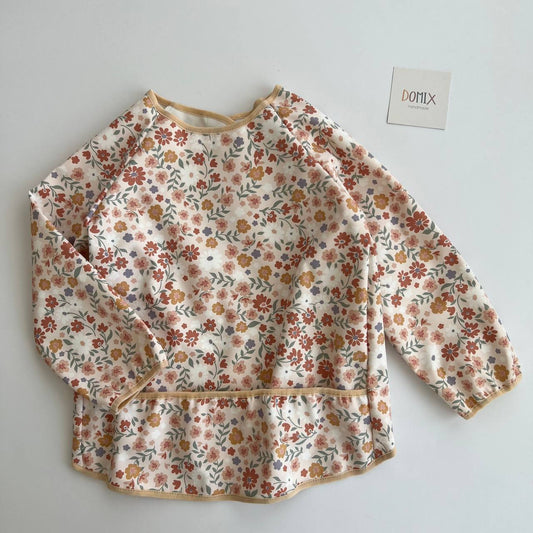 Floral-patterned sweatshirt on a white background with a brand tag visible.