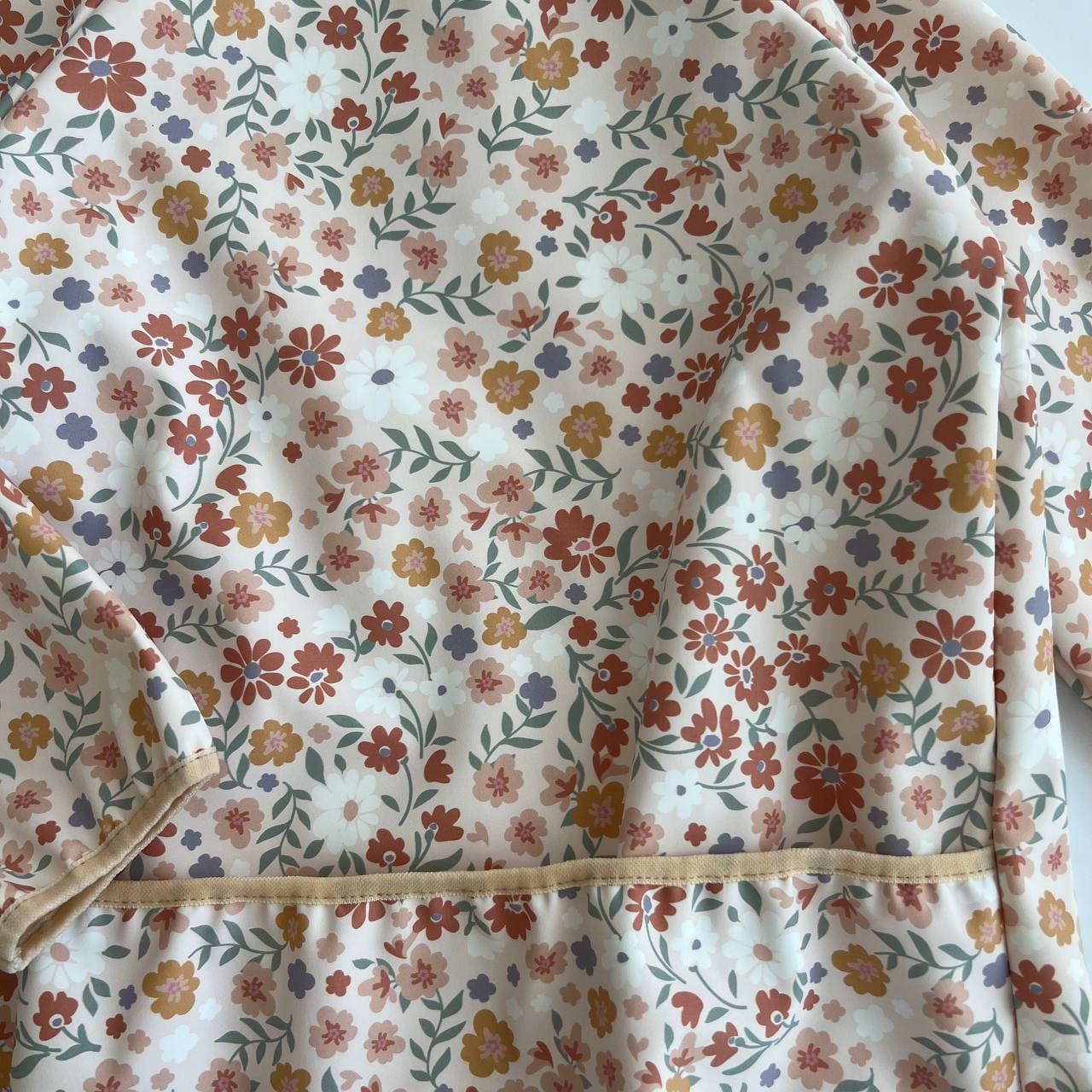 Floral patterned fabric with a visible seam on a white background